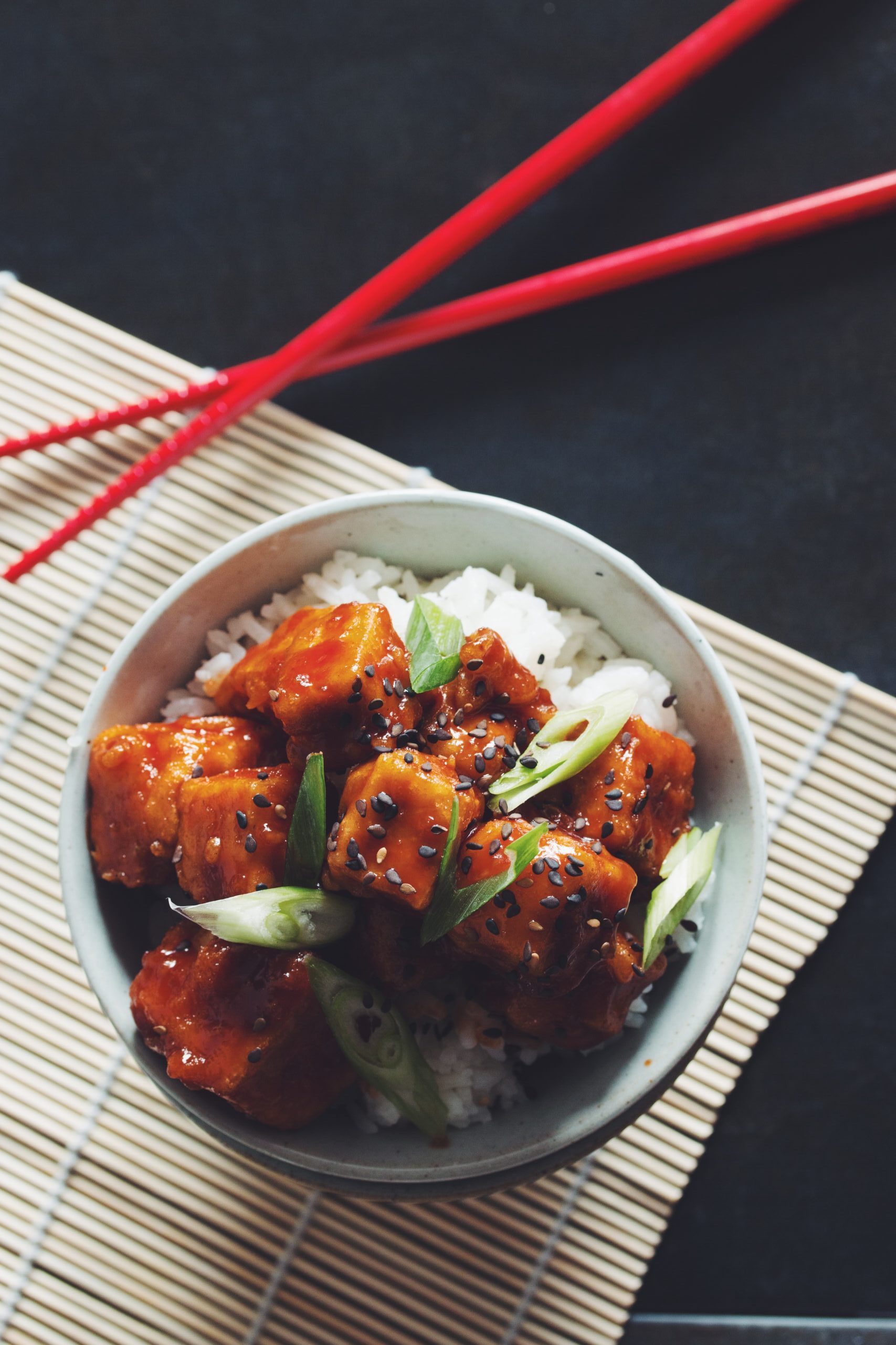 overhead of crispy sweet and sour tofu in a bowl with chopsticks