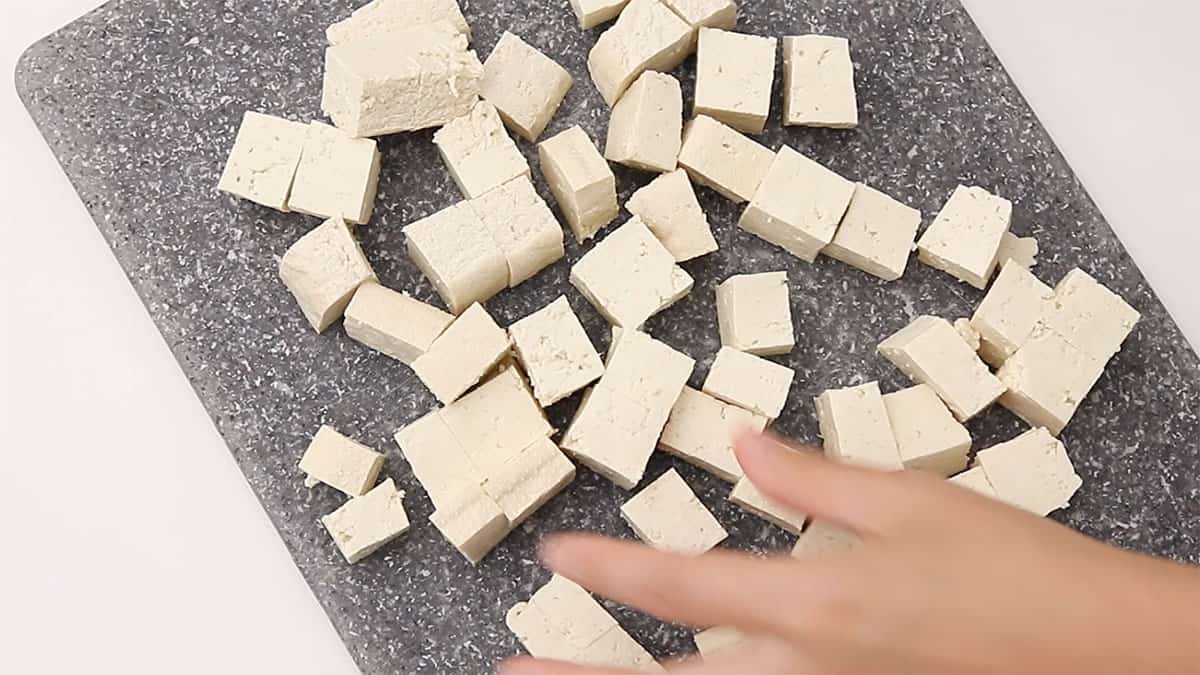 cubes of tofu on a cutting board
