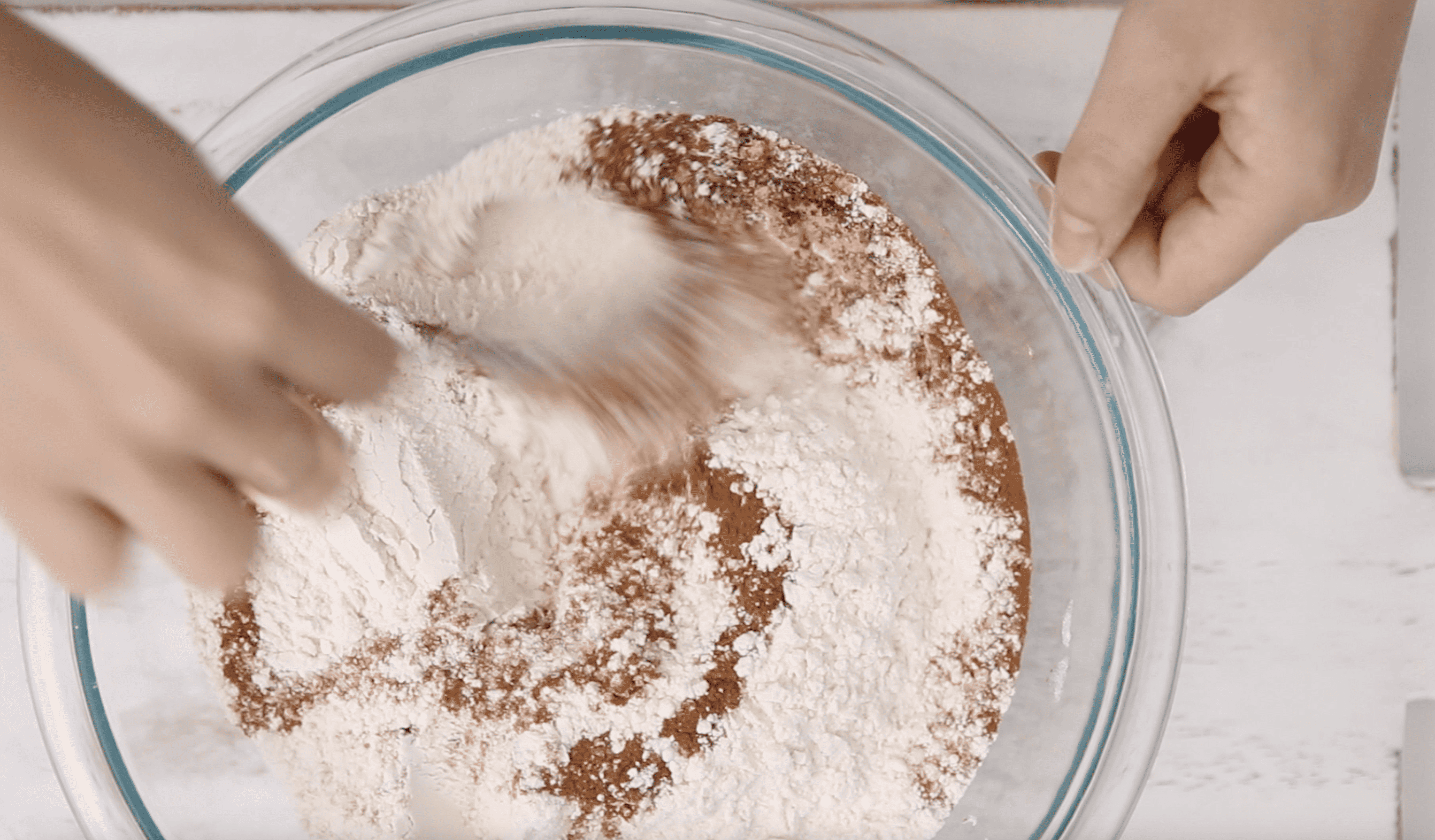 mixing bowl with flour and spices being whisked