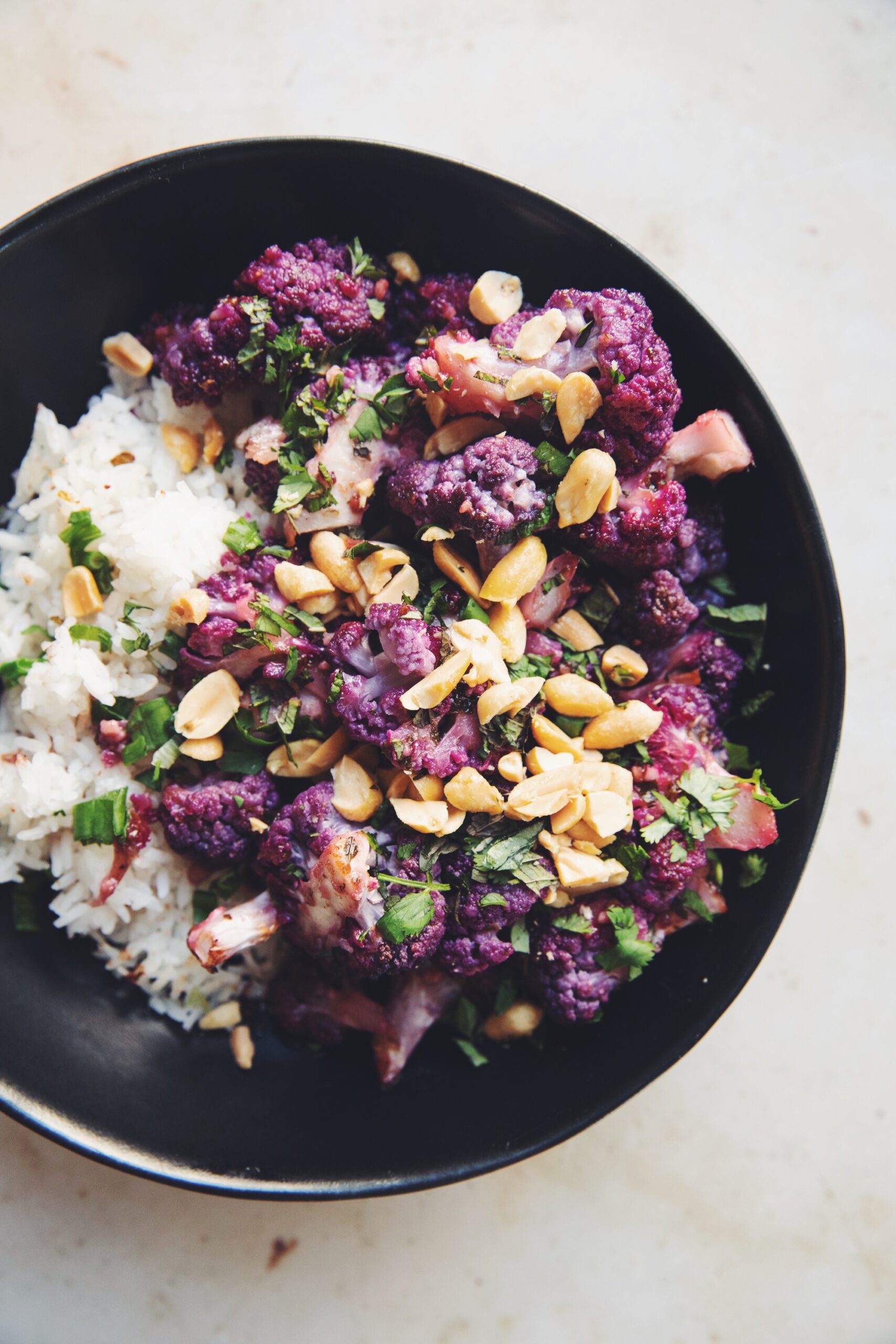 roasted purple cauliflower with rice in a bowl