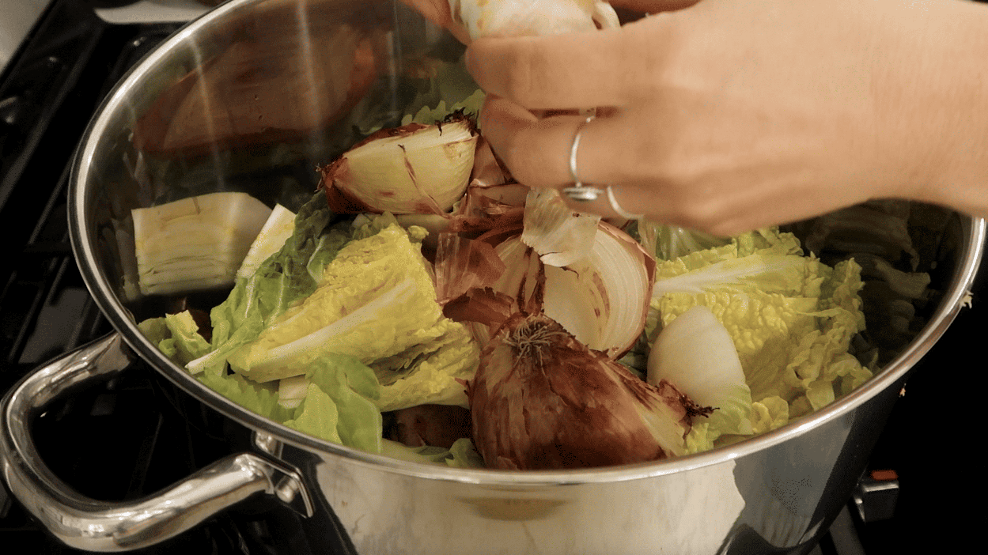 adding roasted vegetables to pot