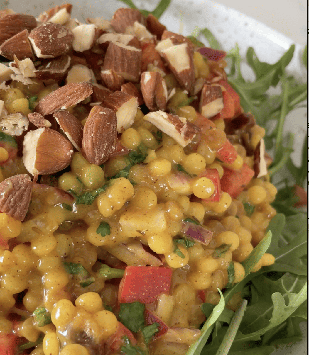 close up of almonds garnished on couscous salad