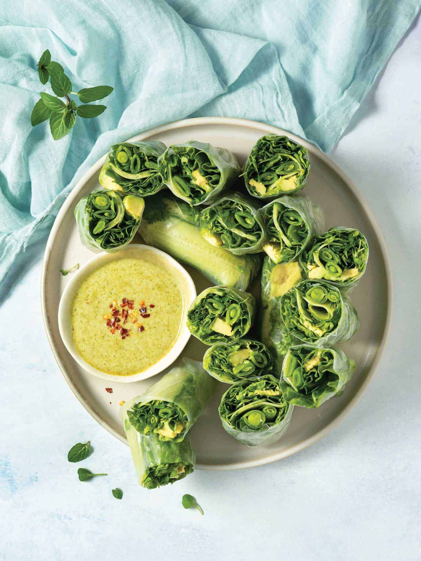 plate of halved vegan summer rolls with dipping sauce