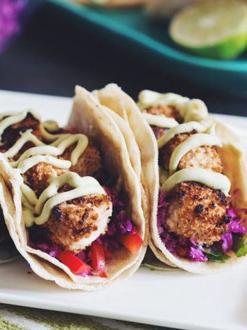 two crispy coconut tofu tacos on a plate